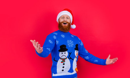 Santa Claus singing Christmas songs studio. Bearded man singing in Santa hat isolated on redの写真素材