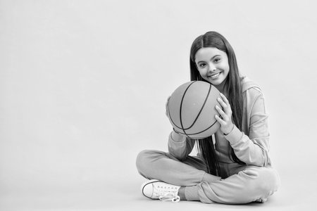 Passionate about basketball sport. Teen sport girl. Teen girl love the sport game of basketball. Teen girl excelling in basketball. teen girl basketball player. Playful childhood sports activitiesの写真素材