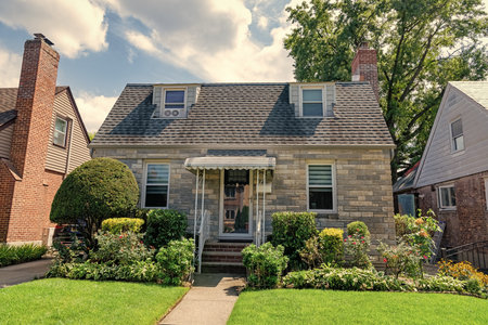 Suburban house architecture. Suburb exterior with housing property. Suburban neighborhood. Private family property. House exterior architecture. Private house in suburban area. Residential buildingの写真素材