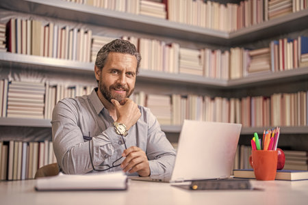 teacher at lesson during estudy. digital classroom. Online education of teacher in classroom. teachers day. teacher man offer education online. online school education. E-learningの写真素材