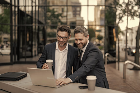 Businessmen investor working on laptop analyzing stock market trading. Investment planning. Business...