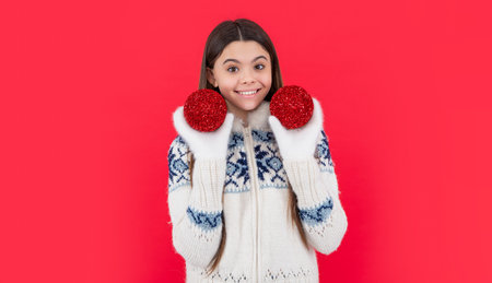 new year. smiling teen girl with red new year decoration in studio. teen new year girlの写真素材