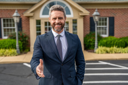 Real estate purchase and sale. Insurance agent deal. Professional realtor dealing with buyer. Businessman broker handshaking. Insurance business. Real estate broker near new house. House for saleの写真素材