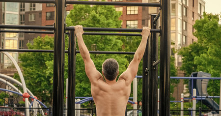 Man pullup at outside gym. Muscular man sportsman with strong back muscle. Sport pullup workout....