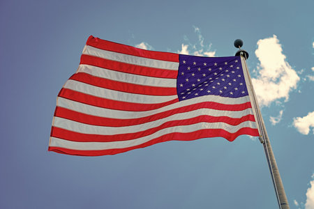 American flag waving for independence day. Flag of the USA. National waving flag of united states on blue sky. Independence day. Patriotic symbol. American Flag for Memorial Day or 4th of Julyの写真素材