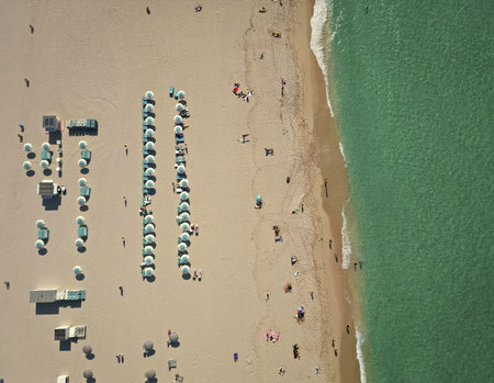 Sea relax under beach umbrella. Travel to sea. Top view of sand beach with turquoise water. Luxury resort. Enjoying beach sun. Summer vacation. Beach vacation at sea in summer. Tropical climateの写真素材
