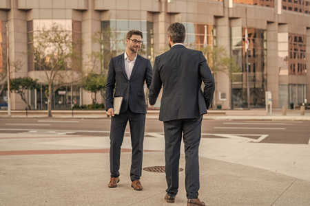 Two businessmen partner celebrating business deal. Successful partnership in business deal. Businessmen dealing outdoor. Partnership success. Celebrate business partnership. Diplomacyの写真素材