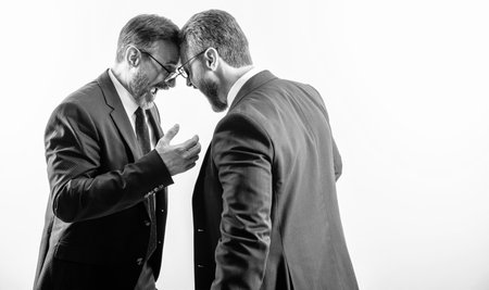 business fight. two businessmen fighting at rivalry isolated on white. businessmen having conflict fight in business. fighting between boss and employee. copy space bannerの写真素材