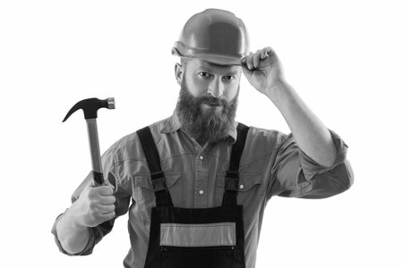 Repair man work. Surface repair. Carpentry and repairing. Repairman in uniform has hammer. Bearded...