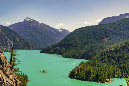 Diablo Lake in North Cascades National Park. Scenic nature view at Diablo lake. Diablo lake with mountain landscape. Landscape of mountain peak and Diablo lake. Nature landscape. Colors of natureの写真素材