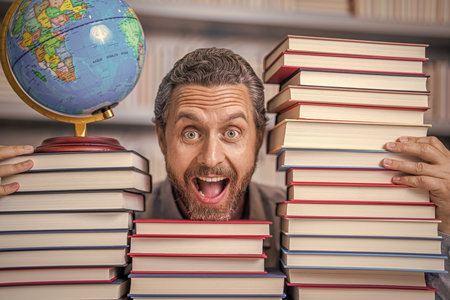 nerd man in classroom. bookworm in school library. education and knowledge. man teacher in class. school education. man nerd with school book. school literature education. Absorbed in a bookの写真素材