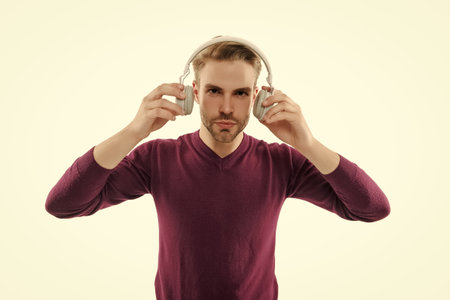 Listen audio. Millennial man gen lifestyle. Lifestyle and music. Man listen music in audio headphones isolated on white. Modern millennial man lifestyle. Music style. Wireless headphonesの写真素材