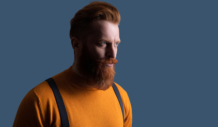 Vintage male fashion style. Male vintage style. Retro man in suspenders isolated on grey. Mature redhead man with hairstyle. Copy space bannerの写真素材
