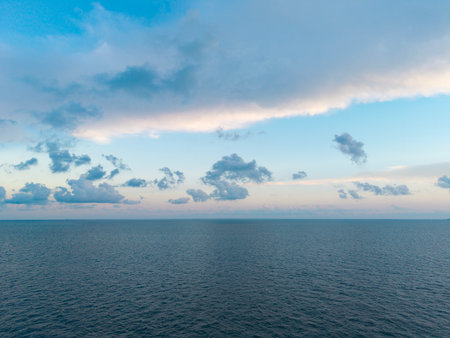 Sunset sea and seascape. Sea horizon view. Cloudy sky and seascape at summer vacation. Skyscape sea horizon. Calm horizon with sea nature. Romantic summer vacation at seascape. Horizon at sunriseの写真素材