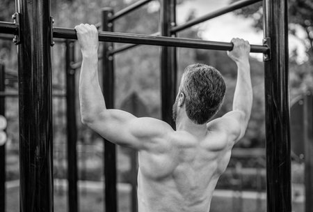 Sport training. Man sportsman do pullup exercise. Muscular biceps and triceps. Strong athlete. Man...