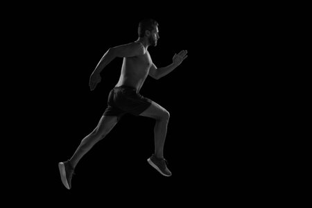 Muscular man running. Sportsman jogger running. Man sportsman running for exercise. Sport athlete man run. Runner at long sport run. Sportsman runner running isolated on black. Sport run. Race dayの写真素材