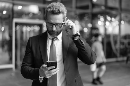 Busy man texting business message. Modern mobile business communication. Businessman messaging on...