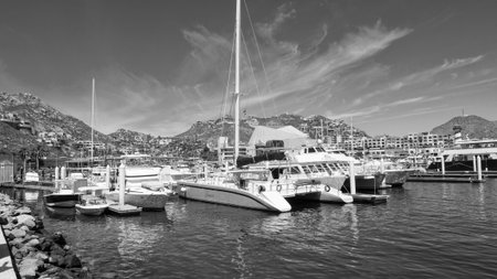 Cabo San Lucas, Mexico - May 15, 2019: Vacation on summer. Catamaran at sea marina. Sea travel. Catamaran sailing in sea. Luxury catamaran yacht in bay. Summer vacation. Luxury travel lifeのeditorial素材