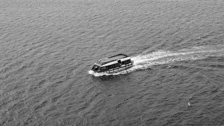 San Juan del Sur, Nicaragua - May 09, 2019: Touristic cruise tender boat in sea. Lifeboat vessel. Tender vessel of cruise ship with people inside. Touristic sea boat. Lifeboat floats on seaのeditorial素材