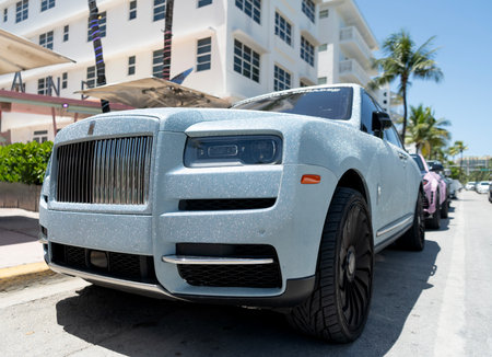 Miami, Florida, USA - July 26, 2025: 2023 Rolls Royce Cullinan luxury SUV with sparkling glowing glitter shimmer tuning. Luxury blue car Rolls Royce Cullinan. Car of Rolls Royce parked, corner viewのeditorial素材