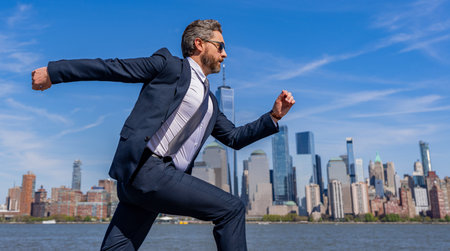 Successful businessman hurrying on New York city skyline. Business man in Manhattan, copy space. Business success in big city. Businessman running to success. Successful deal. Business successの写真素材