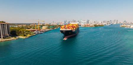 Cargo business. Container ship. Shipping logistics. Commercial shipping. Cargo ship in sea, aerial view. Freight container loaded on cargo vessel. Aerial cargo ship with container. Ship navigationの写真素材