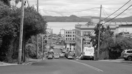 Astoria, Oregon, USA - May 21, 2019: Street of downtown Astoria. Road street in urban city view. City street with car and view on waterfront town. Urban road at city street or avenueのeditorial素材