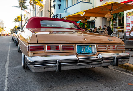 Miami, Florida, USA - April 07, 2025: Car Chevrolet Caprice parked outdoor. Golden Chevy, side view....