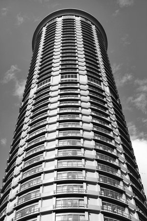 Tower building with skyscraper architecture. Skyscraper hotel in shape of tower. Modern city. Hotel...