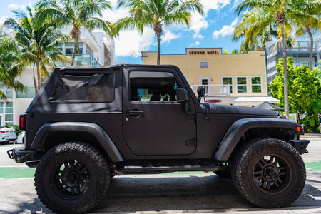 Miami, Florida, USA - April 13, 2025: SUV car Jeep Wrangler. Car Jeep Wrangler parked outdoor. Black...