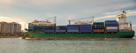 Freight container loaded on cargo vessel. View of cargo ship navigating the sea leaving or entering...