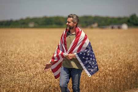 Independence day. Man in field. Patriotic man with American flag in field. Independence day of...
