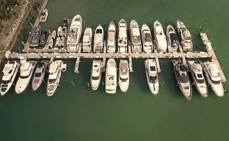 Luxury marina with private yacht and boat. Docked yacht boat in harbor. Luxury summer vacation in Miami. Private boat top view. Marina with sea boat. Yacht club and marina in Miami. Modern marinaの写真素材