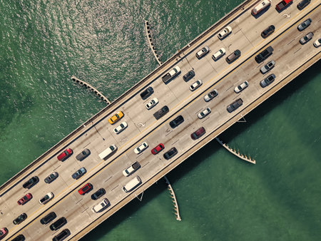 Broad Causeway Bridge spans Biscayne Bay. Urban way connecting town of Bay Harbor Islands to mainland Miami. Top aerial view of the causeway. Key Biscayne bridge. Draw bridge with cars passingの写真素材