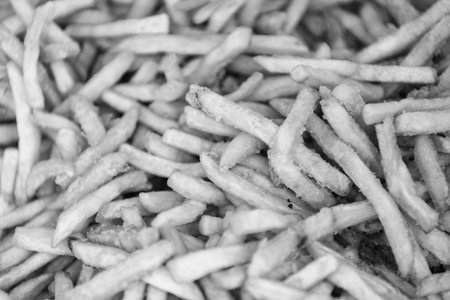 French fries background. Street fast food. Junk food concept. Food background of potato fry. Fried...