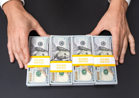 Successful rich man with money. Business success man hold dollar. Millionaire hold dollar money. Riches and success. Rich businessman saving cash money. Financial saving success. Offering moneyの写真素材