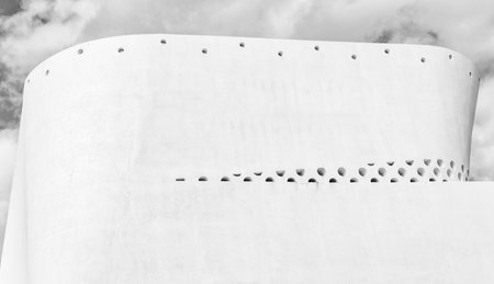 Geometric building design. Modern architecture. Geometric shape. Modern building architecture against blue sky. Architectural geometrical detail. Exterior and facadeの写真素材