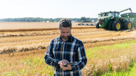 Farmer man working on field with tablet. Hispanic farmer with tablet check harvest. Crop harvest. Farmer agronomist man with tablet in field. Technology of modern agriculture. Crop expertの写真素材