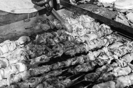 Skewer meat cooking on barbecue, shashlik. Shish kebab on skewer. Chicken BBQ grill. Barbecue grill. Grilled chicken shish kebab. Delicious shish kebab with vegetables. Grilled BBQ pork. Street foodの写真素材