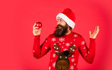 Run xmas party. Prepare for holiday. Ready to celebrate. Bearded man hold christmas decoration. Decorate your home. Organise party. Winter inspiration. New year party decor. Decor shop salesの写真素材