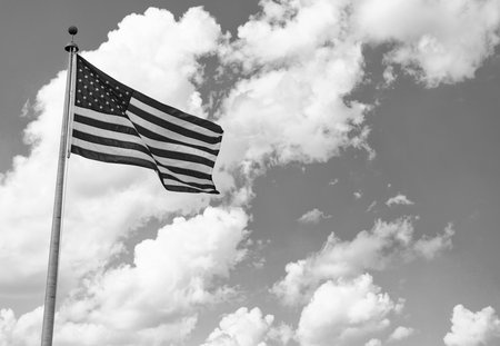 American Flag for Memorial Day or 4th of July. American flag waving in the wind. Flag of the USA. National waving flag of united states on blue sky. Independence day. Patriotic symbolの写真素材
