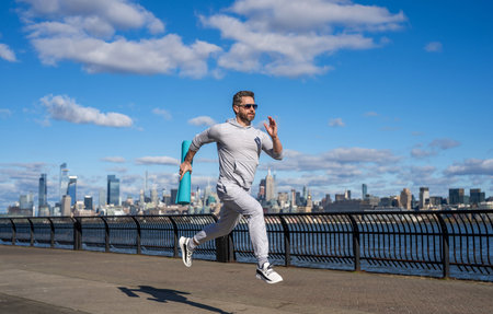 Man in sports suit training jogging. Running man. Morning sport workout jogger run. The jogger run...