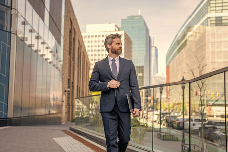 Business success man outdoor. Businessman walk to business successful meeting in city. Business...
