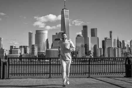 Sportsman jogger running. Morning sport workout runner running. Sport runner in Manhattan. Sportsman in New York. Man sportsman running for exercise in active wear. Fitness and sportの写真素材