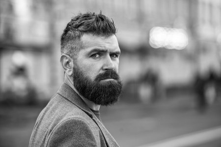 Bearded businessman face portrait outdoor, copy space. Bearded man wearing street style. Businessman in the city. City street with business man. Man style. Stylish man in casual business styleの写真素材