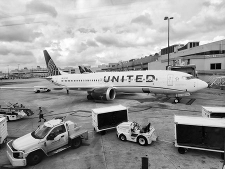 Chicago, Illinois, USA - November 07, 2024: United airline plane departure in airport. Airport terminal and loading cars. Plane arrival of United airline. Departure and arrival at airportのeditorial素材