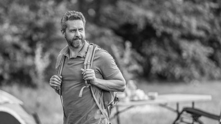 Man having camp picnic in forest with tent. Man hiking on summer day. Summer camp activity. Summer camping retreat. Camp adventure. Hiking lifestyle. Man at campsite. Picnic time. Copy spaceの写真素材