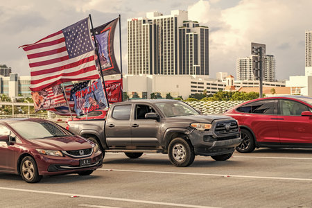 Miami, Florida, USA - November 03, 2024: 2023 Toyota Tacoma pickup truck on road with American and...