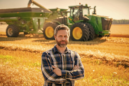 Agronomist man harvesting at crop field. Ripe agriculture. Harvest man at field. Farmer agronomist....