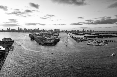 Sunset in port in Florida. Port of Miami on sunset. Miami port with cargo ship. Harbor marina sunset landscape. Travel destination. Cargo ship docked in port of Miami. Miami south beach, Floridaの写真素材